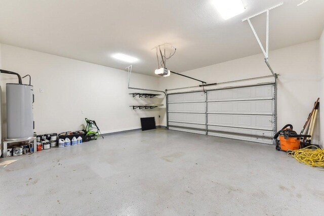 garage with a garage door opener and water heater