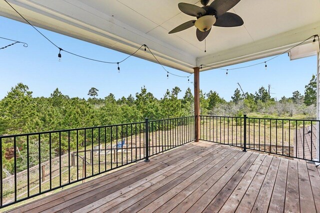 wooden terrace featuring ceiling fan