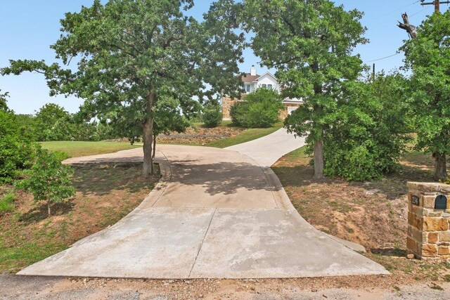 view of community with curved driveway