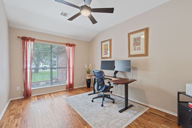 office area featuring visible vents, wood finished floors, baseboards, ceiling fan, and vaulted ceiling
