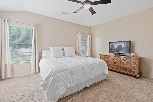 bedroom featuring a ceiling fan, baseboards, visible vents, and light carpet