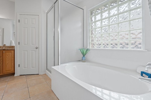 14529 Wharton Park Trl, Austin, TX 78717 - full bath with a stall shower, a bath, tile patterned floors, and vanity