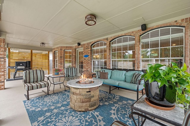 view of patio featuring an outdoor living space with a fire pit and a porch