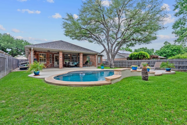 view of pool with a yard, a patio, and a fenced backyard