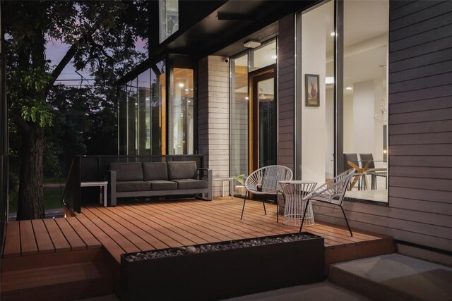 wooden terrace with an outdoor hangout area