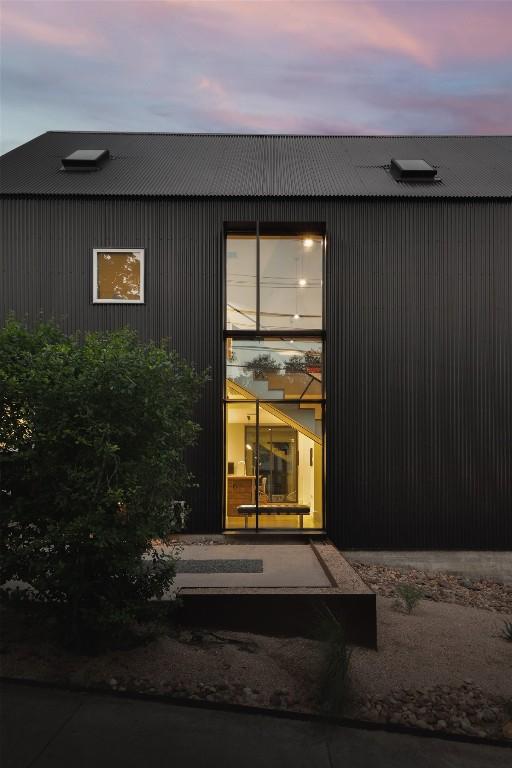 doorway to property with metal roof