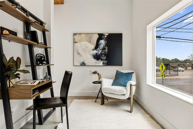 office space with baseboards and carpet flooring
