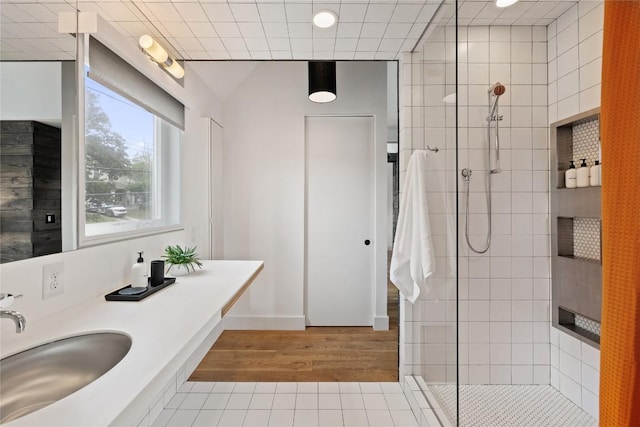 full bath featuring a sink, a walk in shower, and tile patterned floors