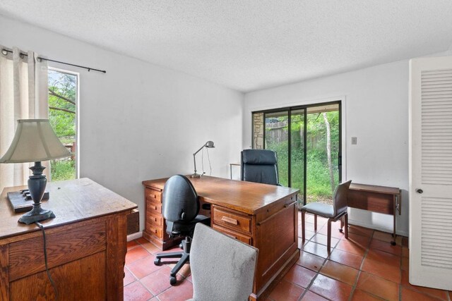 office featuring tile patterned flooring and a textured ceiling