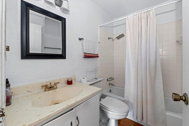 full bath featuring toilet, a textured ceiling, shower / bath combo, and vanity