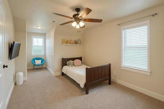 bedroom featuring baseboards, light carpet, and visible vents