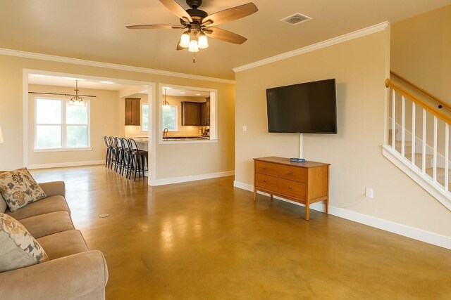 living area with visible vents, finished concrete flooring, crown molding, stairway, and baseboards