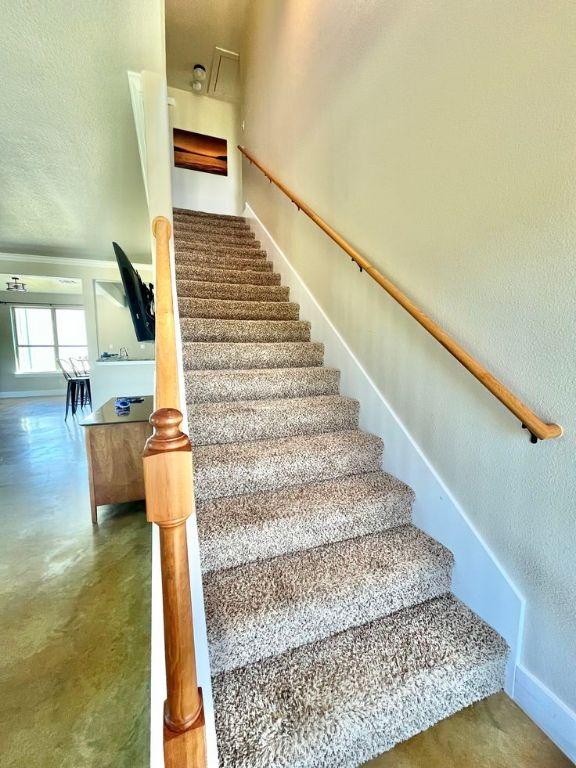 923 Debco Ln, Spicewood, TX 78669 - stairway with baseboards and finished concrete floors