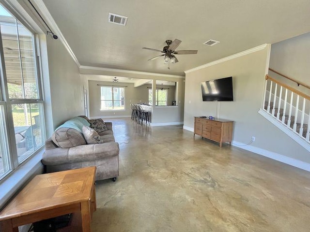 923 Debco Ln, Spicewood, TX 78669 - living area featuring ornamental molding, finished concrete floors, baseboards, a ceiling fan, and stairway