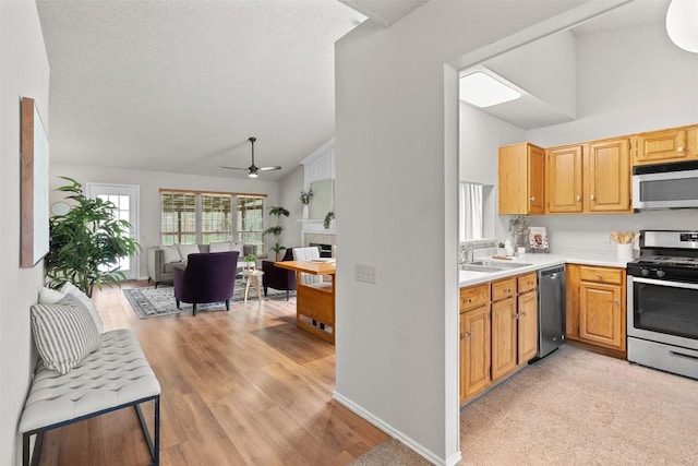 kitchen featuring light countertops, ceiling fan, high vaulted ceiling, and stainless steel appliances