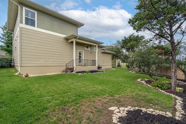 1766 Rowdy Loop, Leander, TX 78641 - rear view of house featuring a yard and fence
