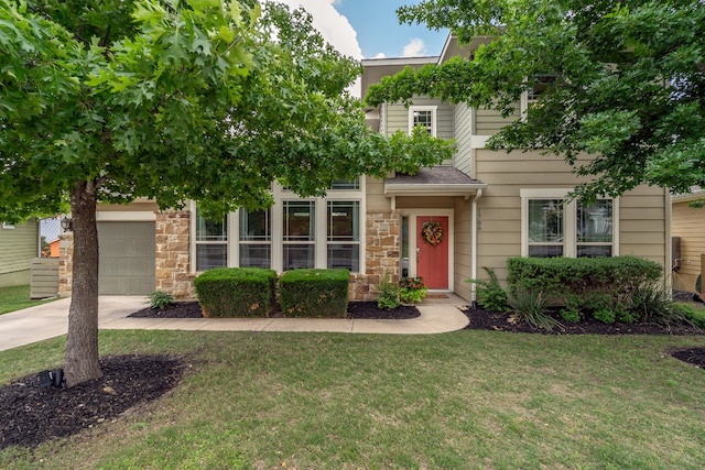 1766 Rowdy Loop, Leander, TX 78641 - view of front of property with concrete driveway, an attached garage, stone siding, and a front lawn
