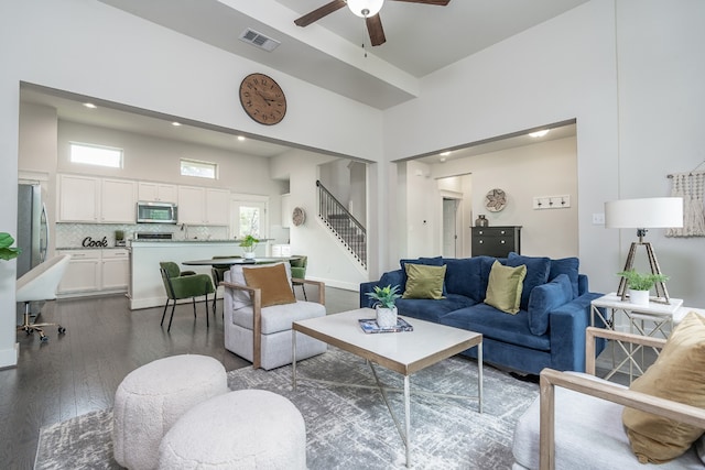 1766 Rowdy Loop, Leander, TX 78641 - living area featuring ceiling fan, visible vents, high vaulted ceiling, stairs, and dark wood-type flooring