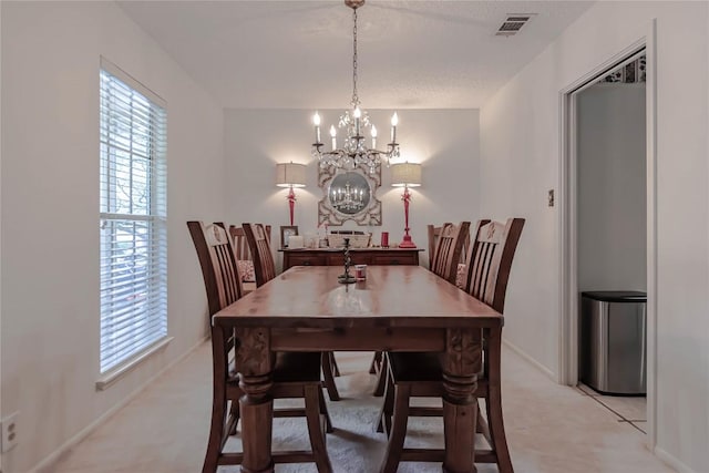dining area with a healthy amount of sunlight, baseboards, a notable chandelier, and visible vents