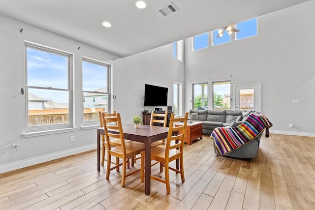 dining space with a healthy amount of sunlight, light wood-style flooring, and visible vents