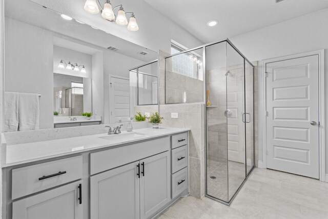 120 Freeman Loop, Liberty Hill, TX 78642 - bathroom with vanity, a shower stall, and tile patterned flooring