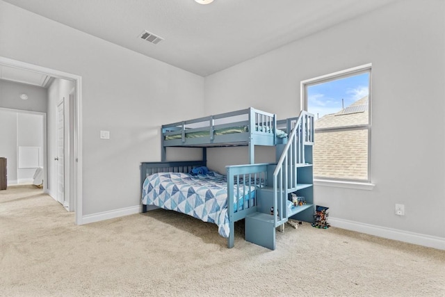 bedroom featuring carpet floors, baseboards, attic access, and visible vents