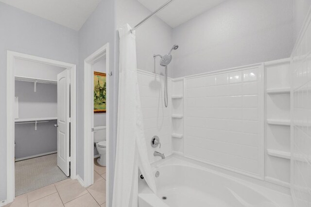 full bathroom with toilet, tile patterned flooring, and shower / bath combo with shower curtain