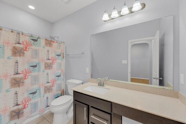 bathroom featuring toilet, tile patterned flooring, and vanity