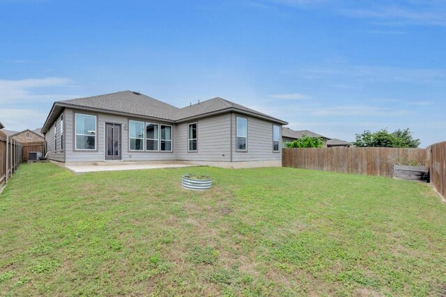 back of house with a patio, a fenced backyard, and a lawn