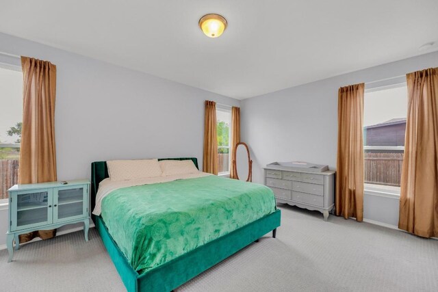 bedroom with carpet flooring and baseboards