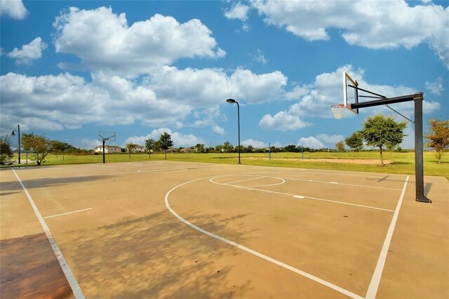 view of sport court featuring community basketball court and a yard