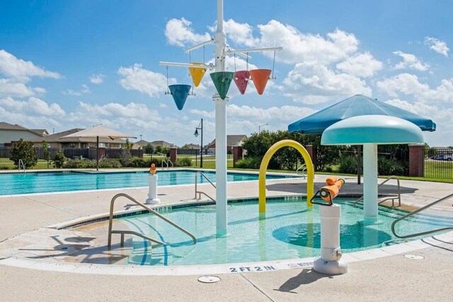 pool with fence and a patio area
