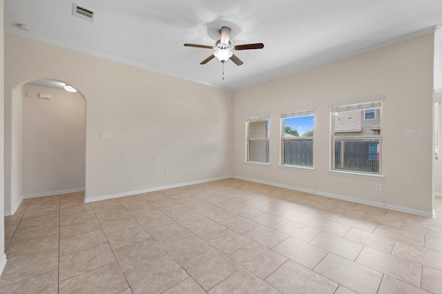 spare room with crown molding, ceiling fan, arched walkways, light tile patterned floors, and visible vents