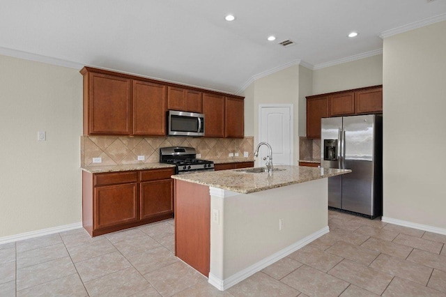 kitchen featuring backsplash, visible vents, appliances with stainless steel finishes, light stone countertops, and a sink