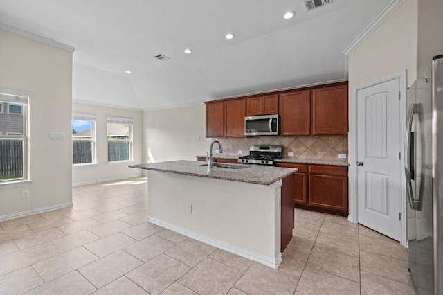 kitchen featuring backsplash, visible vents, a sink, lofted ceiling, and stainless steel appliances