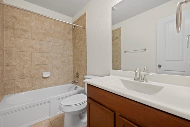 bathroom featuring vanity, toilet, tile patterned floors, and bathtub / shower combination