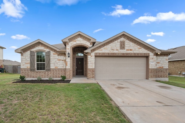 view of front of property featuring stone siding, a garage, brick siding, a front yard, and driveway