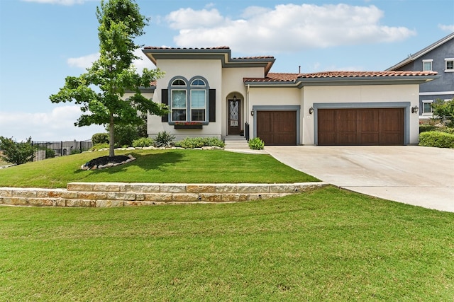mediterranean / spanish-style house featuring a front yard, stucco siding, an attached garage, driveway, and a tile roof