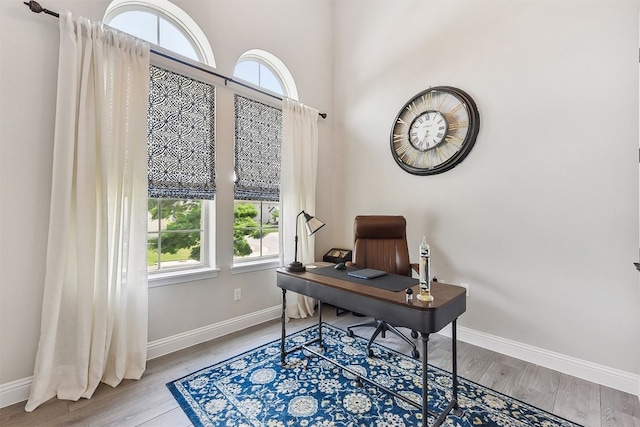 office space featuring baseboards and wood finished floors