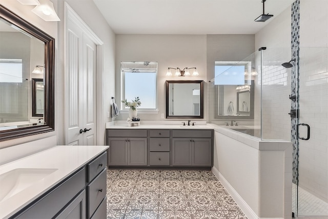 full bathroom featuring tile patterned flooring, a sink, two vanities, and a shower stall