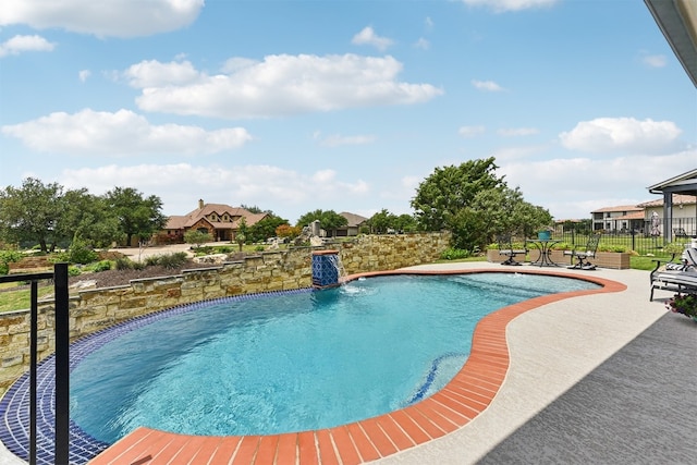 outdoor pool featuring a patio and fence