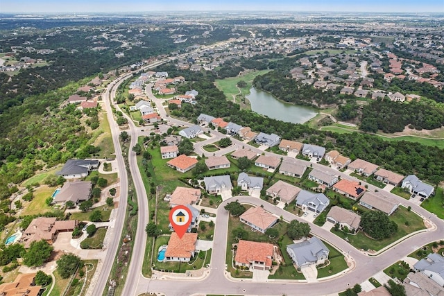 birds eye view of property featuring a water view and a residential view
