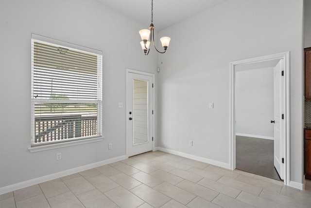 interior space with baseboards and a notable chandelier