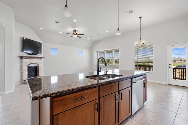 kitchen with visible vents, a sink, dishwasher, and a fireplace