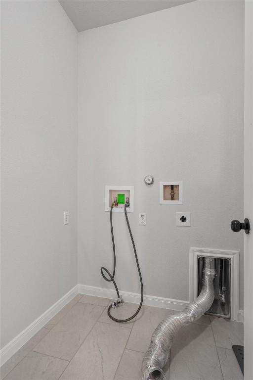 laundry room with laundry area, hookup for a washing machine, gas dryer hookup, baseboards, and electric dryer hookup