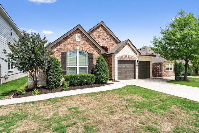 8105 Porto Cv, Round Rock, TX 78665 - view of front of house with a garage, a front lawn, concrete driveway, and brick siding