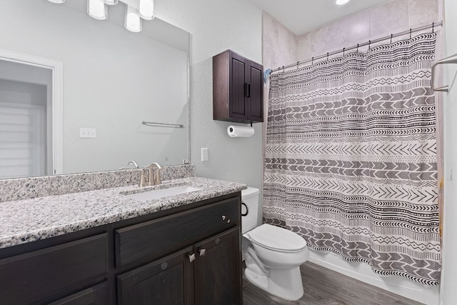 full bathroom with vanity, wood finished floors, and toilet