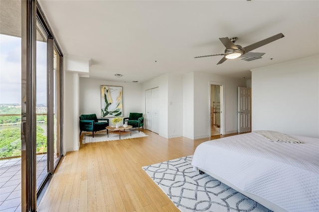 40 N Interstate 35 Unit 10B1, Austin, TX 78701 - bedroom with light wood-style flooring, access to outside, and ceiling fan