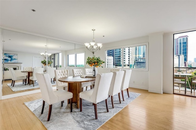 40 N Interstate 35 Unit 10B1, Austin, TX 78701 - dining room with a chandelier and light wood finished floors