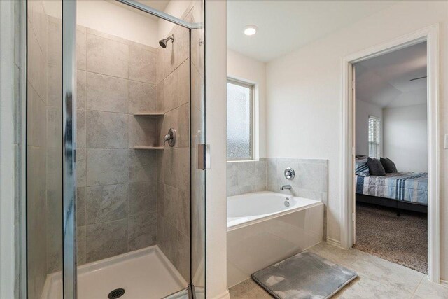 full bathroom with a garden tub, ensuite bathroom, tile patterned flooring, and a shower stall